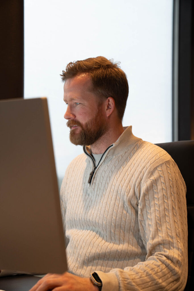 Bilde av en mann som jobber på en mac